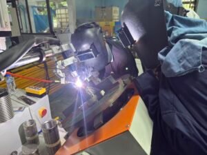 Automatic TIG welding of a braided corrugated stainless steel hose fitting for liquid cooling hose production