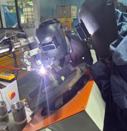 Automatic TIG welding of a braided corrugated stainless steel hose fitting for liquid cooling hose production