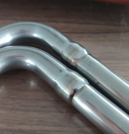Closed orbital TIG welding head for automatic welding of a bent tube joint