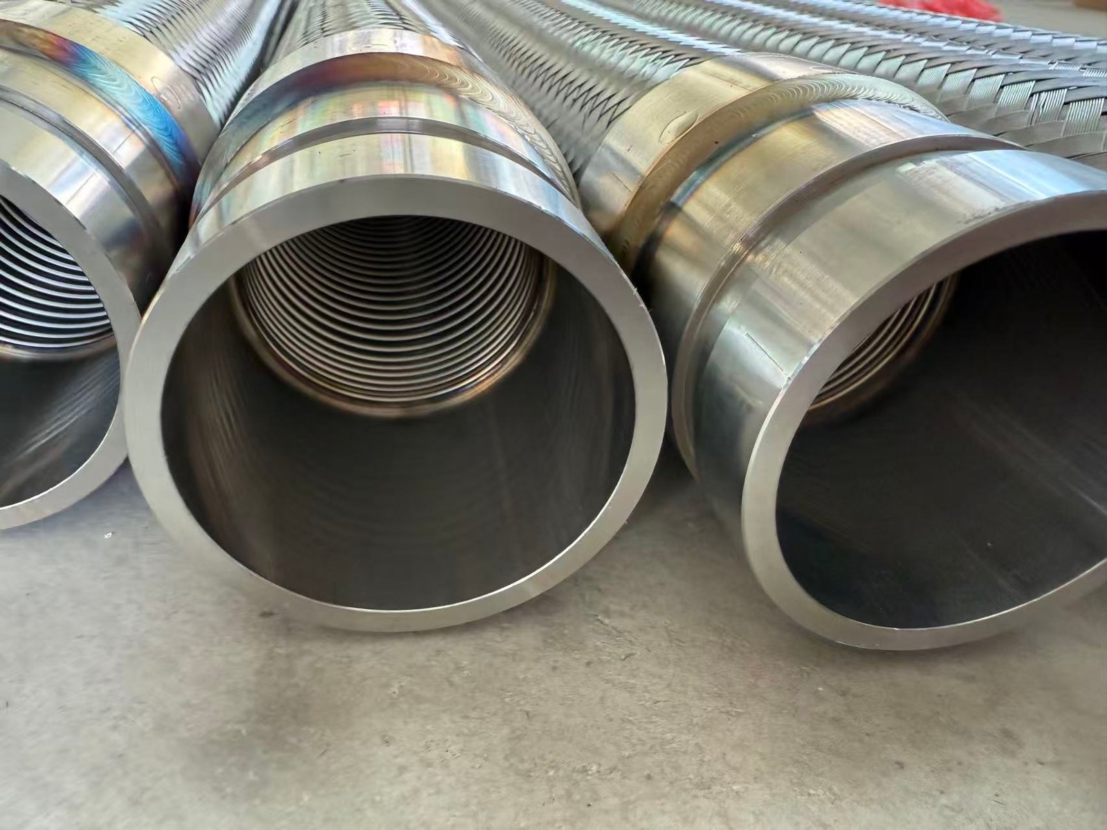 Large-diameter braided metal hoses with welded stainless steel fittings for industrial fluid piping applications