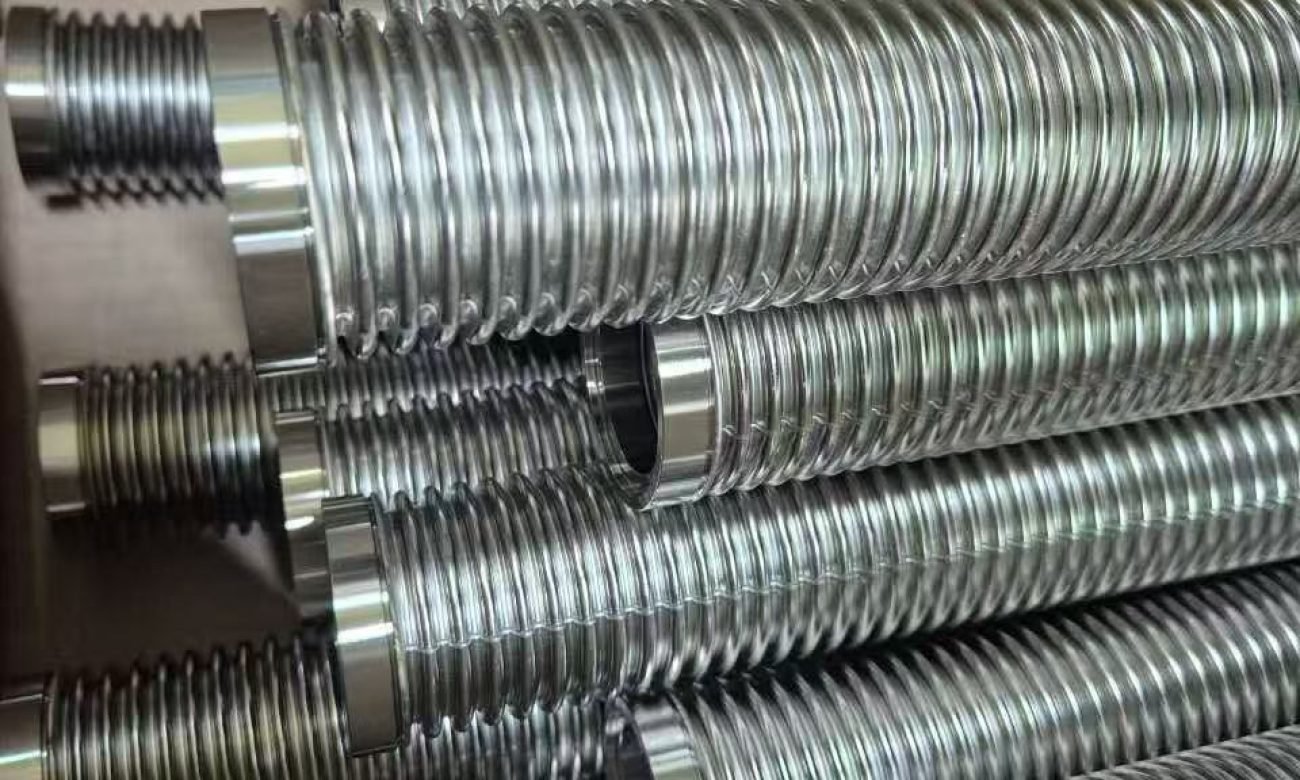Corrugated stainless steel hoses with welded end fittings before wire braid assembly.